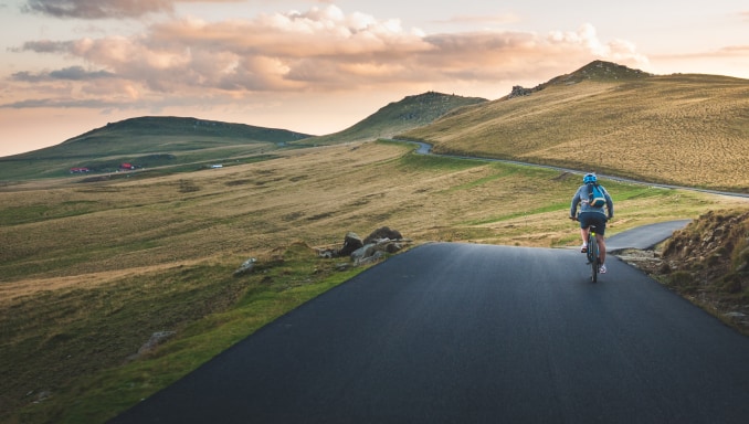 Cyclist cycling through mountains